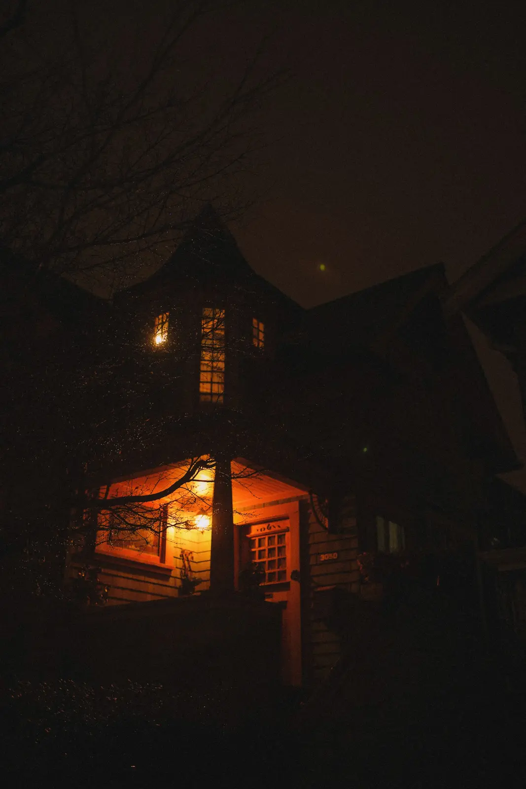 A house at night with the porch light on